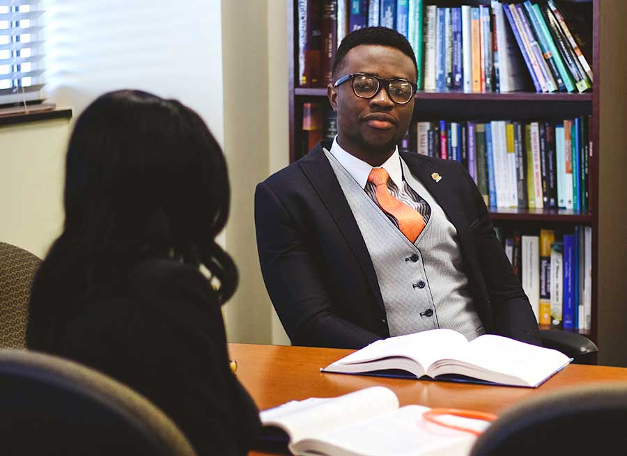Two students in the HCA program sitting and talking
