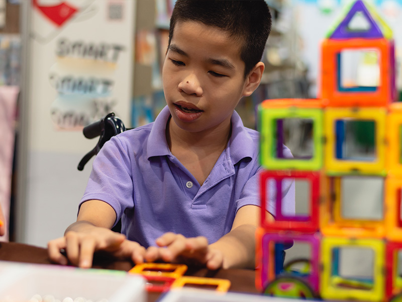 A special education student working with block toys