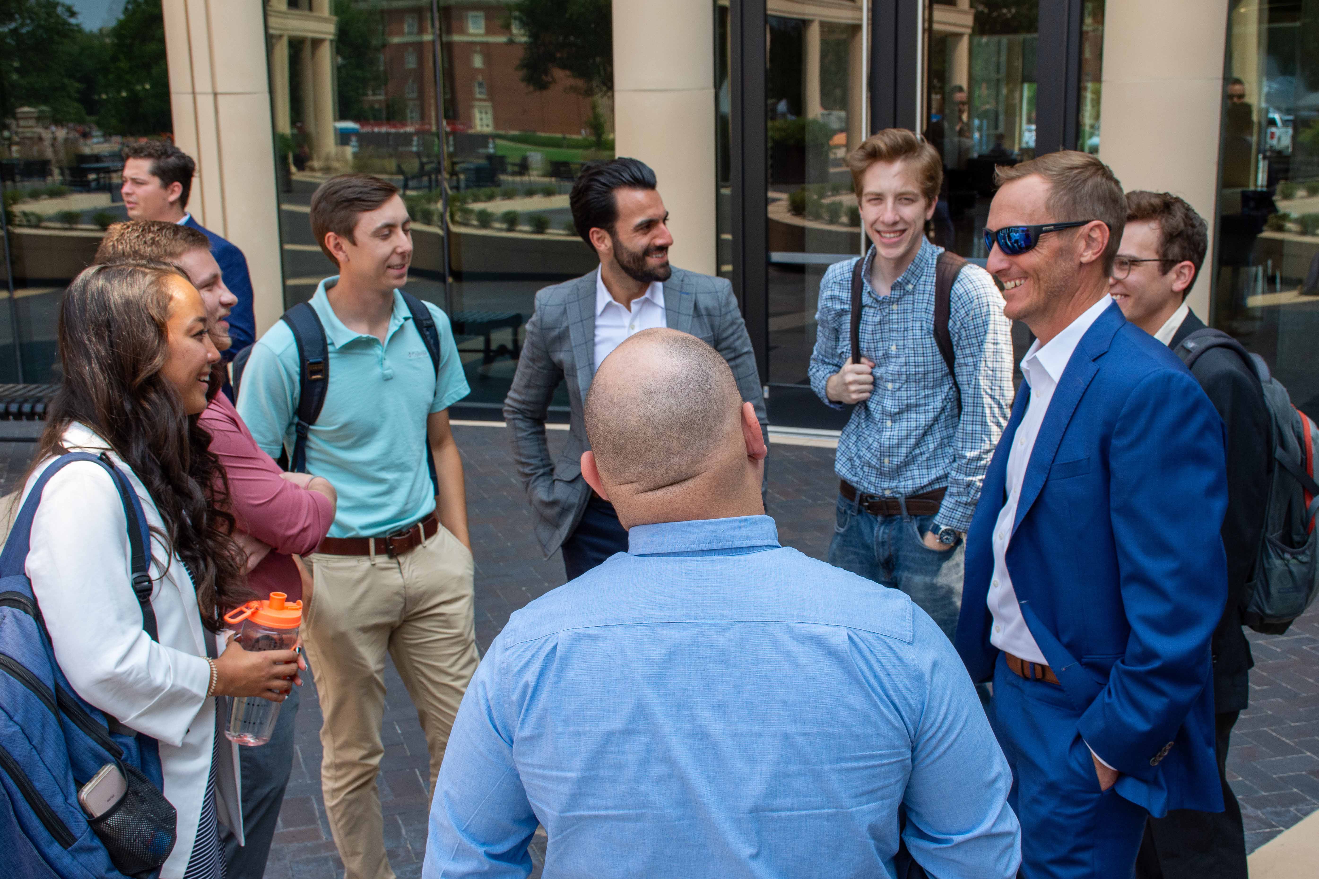 Master students and representatives smiling in gathering